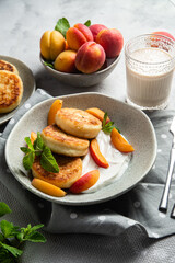 Cottage cheese pancakes with sour cream and apricots