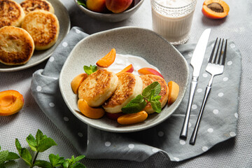 Cottage cheese pancakes with sour cream and apricots