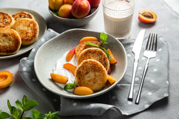Cottage cheese pancakes with sour cream and apricots