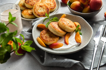 Cottage cheese pancakes with sour cream and apricots