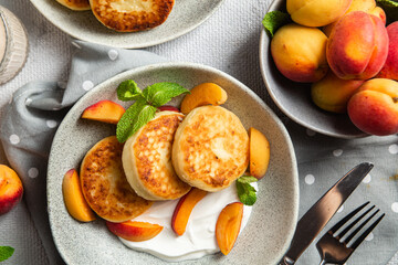 Cottage cheese pancakes with sour cream and apricots