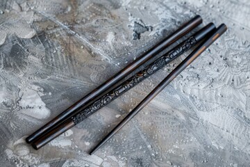 Two wooden chopsticks sit side by side on a table, ready for use