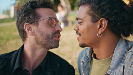 Fototapeta premium Couple men unconventional orientation portrait kissing on nature. Gay lovers