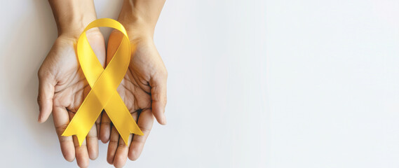 A person holding a yellow ribbon in their hands
