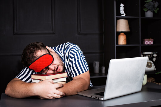 Funny fat man sleeps alone at work in the office.