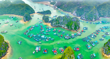 Floating fishing village and rock island in Lan Ha bay, Vietnam, Southeast Asia. UNESCO World Heritage Site. Popular landmark, famous destination of Vietnam. Near Halong bay © huythoai