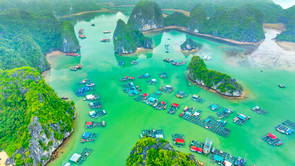 Floating fishing village and rock island in Lan Ha bay, Vietnam, Southeast Asia. UNESCO World Heritage Site. Popular landmark, famous destination of Vietnam. Near Halong bay