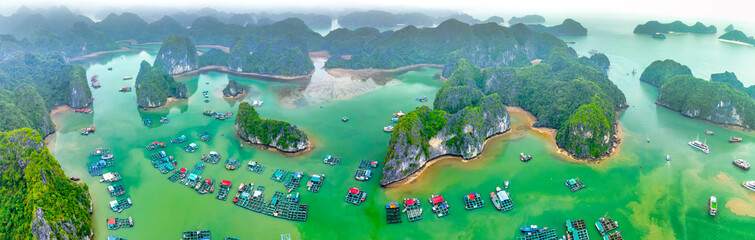 Floating fishing village and rock island in Lan Ha bay, Vietnam, Southeast Asia. UNESCO World...