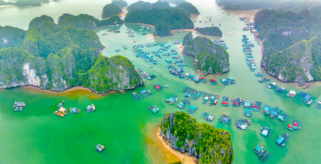 Floating fishing village and rock island in Lan Ha bay, Vietnam, Southeast Asia. UNESCO World...