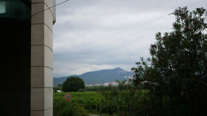 view from below on the barcelona city and hills