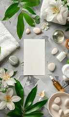 Blank white card mockup with spa items like towels, stones, and flowers, on a gray background