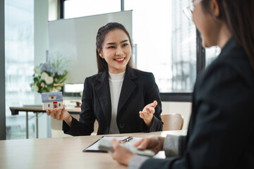 Real Estate Agents Discussing Home Buying and Selling Contracts in Modern Office Setting