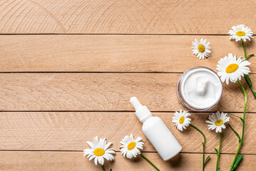 Natural organic face cream and serum with chamomile flowers