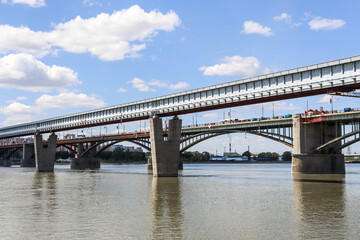 Naklejka premium Novosibirsk, Novosibirsk region, Russian Federation - June 01 2024. Novosibirsk metro bridge and Oktyabrsky bridge