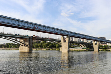 Naklejka premium Novosibirsk, Novosibirsk region, Russian Federation - June 01 2024. Novosibirsk metro bridge and Oktyabrsky bridge