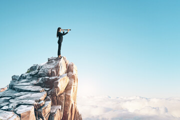A person standing on a high cliff peak using binoculars, with a clear blue sky and cloud background, concept of vision and exploration. Generative AI