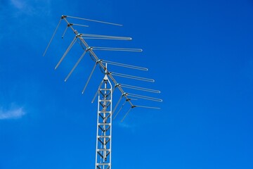 Yagi antenna set against bright blue sky