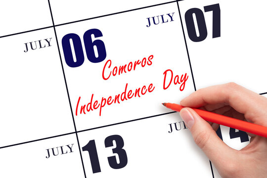 July 6. Hand writing text Comoros Independence Day on calendar date. Save the date. - Powered by Adobe