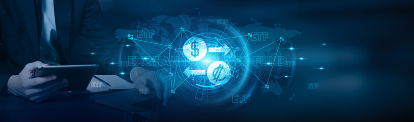 Exchange-traded fund. Businessman using laptop and monitoring ETF performance with a focus on market growth on stocks, bonds, commodities, currencies, and alternative investments on the global network