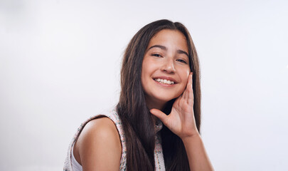 Fototapeta premium Happy girl, teenager and portrait for beauty in studio, pigmentation and confidence for melanin. Female person, smile and proud of skin on white background, mockup space and freckles for wellness