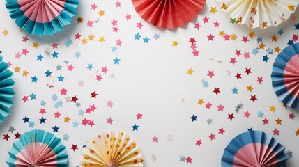 Fototapeta premium This image features colorful pinwheels and star-shaped confetti scattered on a white background, creating a festive and cheerful ambiance perfect for celebrations and parties.