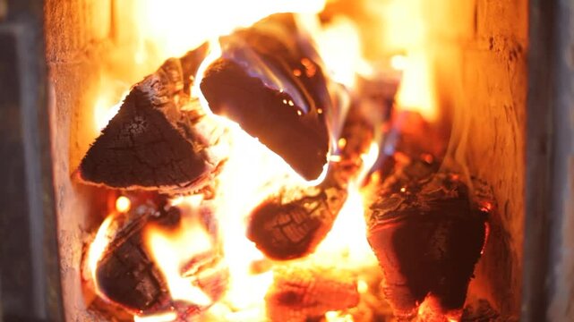 Wood burner stove with wood fire burning brightly. 