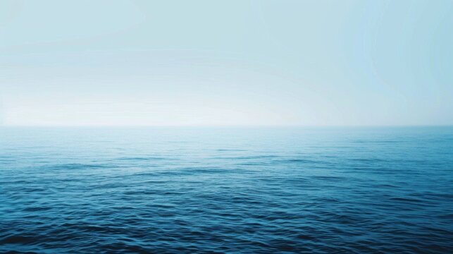 The image features a tranquil ocean with gentle waves under a serene blue sky, offering a peaceful view of the distant horizon with a sense of infinite calmness.