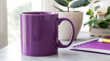 Modern office desk featuring a large purple mug, notepad, and a Ficus plant.