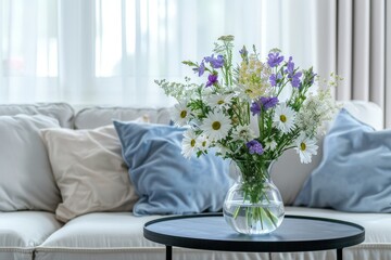 Fresh Bouquet of Purple and White Flowers in Clear Vase on Round Table