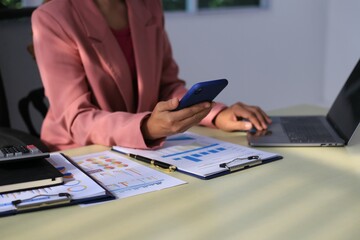 Fototapeta premium Image of a young Asian female company employee smiling and holding a digital tablet standing on a white background.