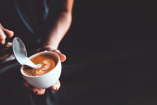 vintage tone of barista pour milk to making latte art coffee at cafe or coffe shop