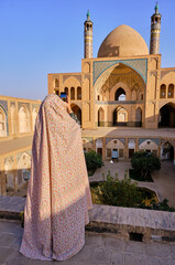 Woman in Iran by taking photo of Agha Bozorg Mosque, Inner Courtyard Kashan, Iran, Middle East.