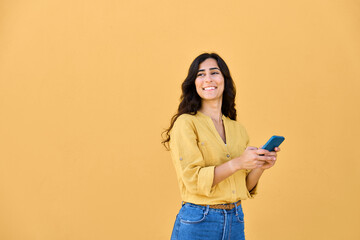 Young middle eastern brunette woman in casual clothes using mobile cellphone app for communication,...