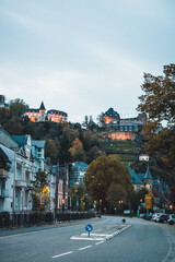 Evening View of a Picturesque Village with Illuminated Castle on Hill