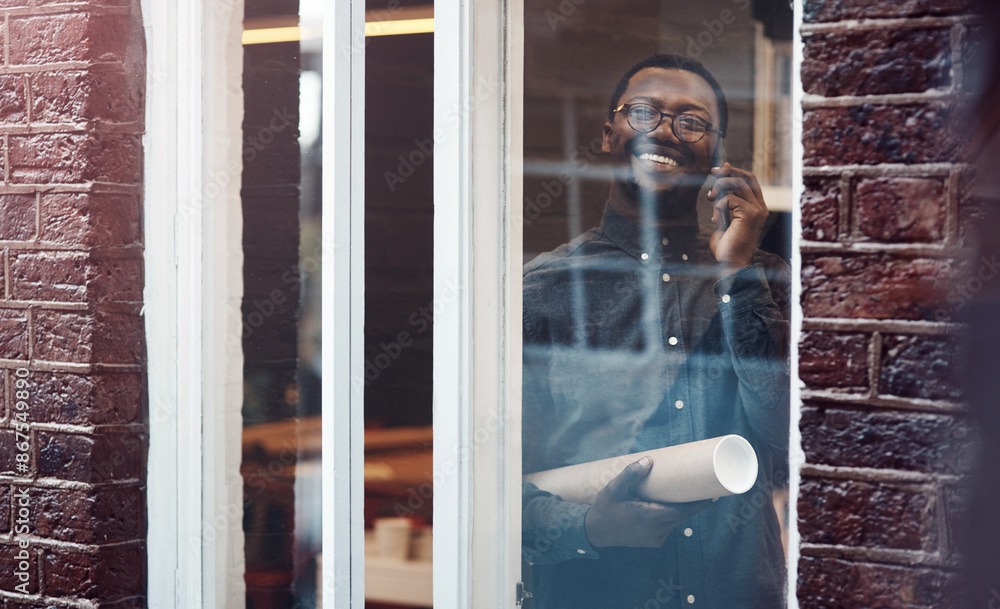 Poster Man, architect and phone call in office with documents in roll, blueprint and negotiation with contractor. African person, smartphone and smile by window in conversation, floor plan and decision