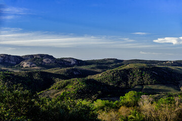 Fototapeta premium view of the mountains, landscape with sky, landscape with trees and clouds, rural landscape, caatinga landscape, northeastern Brazil, Pedra da Boca, landscape with mountains, sunny day 