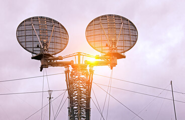 Twin Radar Dishes Pierce the Cloudy Sky