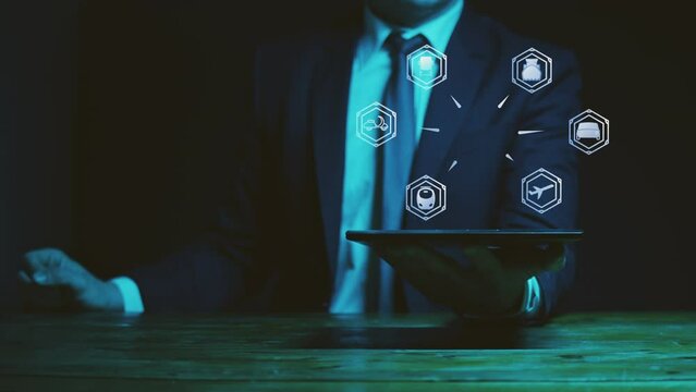 A man in a suit holds a graphics tablet above which there is a hologram with digital symbols of vehicles using carbon fuel. The concept of getting rid of sources of air pollution. Cg