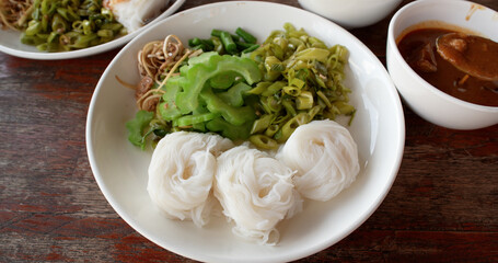 Thai rice flour noodles or lightly fermented rice noodles with coconut curry sauce or Kanom Jeen Nam Prik, Thai famous food.