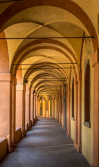 Sunlit Arches of the Historic Portico di San Luca in Bologna, Italy
