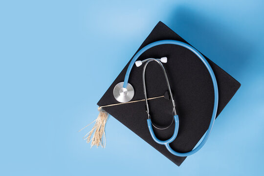 Medical education, graduation cap and doctor's stethoscope, student completing degree in medicine, college ceremony recognizing academic success - Powered by Adobe
