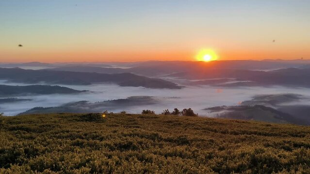 sunrise over foggy mountains, morning on Carpathian mountain top, horizontal footage