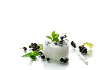 homemade sweet yogurt in a jar with black currants, isolated on a white background