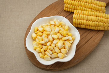 Raw fresh corn seeds on white bowl
