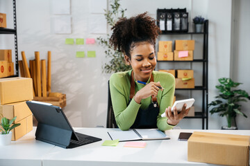 African Owner SME Small and Medium Enterprises woman received orders from clients and check profit...