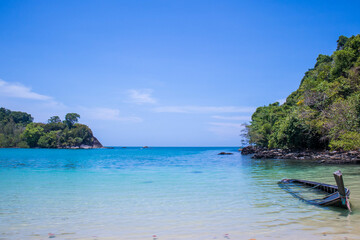 Beautiful sandy beach with long tail boats anchored on the beach of Koh Kamtok, Ranong Province, Thailand, Asia