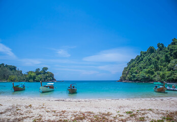 White sand beach and Long-tail boat at Kham-Tok Island (koh-kam-tok), The beautiful sea Ranong Province, Thailand.