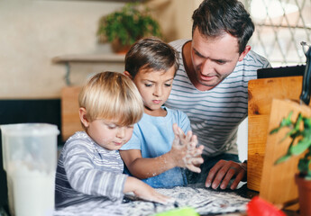 Baking, playing and father with children in kitchen with ingredients for learning, bonding and recipe. Family, home and dad with young boys with flour to bake cookies, biscuits and treats together