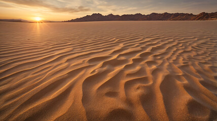 The setting sun casts a brilliant glow over the expansive rippled Saudi Arabian desert