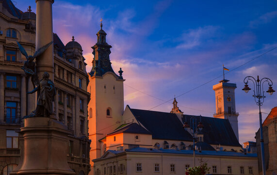 Adam Mickiewicz momument in Lviv Ukrainian city square touristic heritage site city scape landmark urban view in sunset romantic natural light purple and blue colors sky